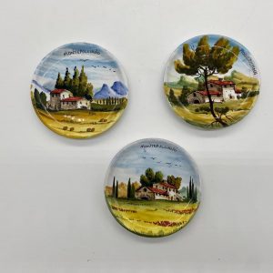 Three plates decorated with a Tuscan landscape