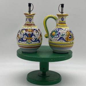 Pair of oil and vinegar bottles with decorations by Raffaello
